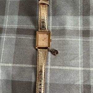 Michael Kors watch with charm. Rose gold band and casing. Great condition.